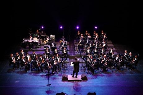 Image of an orchestra and conductor on stage 
