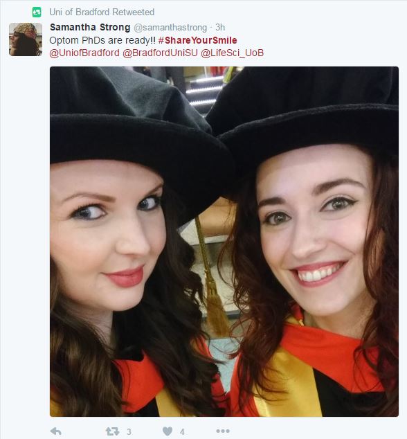 Two girls dressed in graduation robes