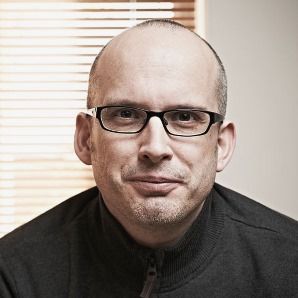 Head shot image of Paul Boag wearing black top and glasses