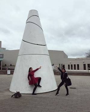 Image of two girls posing in front of monument 